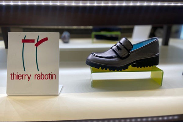 Thierry Rabotin Maractus Leather And Patent Loafer Women's New Spring Harry's Shoes Upper West Side NYC Lifestyle Shoe On Green Pedestal On Lighted Table Next To Logo
