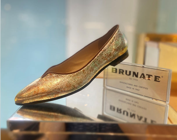 Brunate Eden Metallic Leather Ballet Flat Lifestyle On Logo On Reflective Rectangle Harry's Shoes Upper West Side NYC